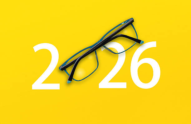 istock 2026 with glasses on yellow isolated background 2220564330