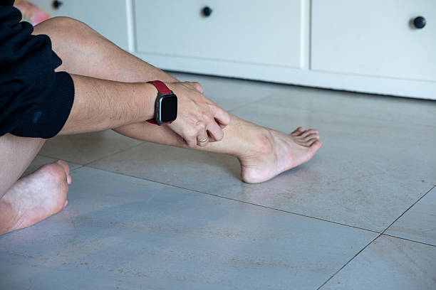 istock Asian woman is scratching her leg due to itching. 2220565587