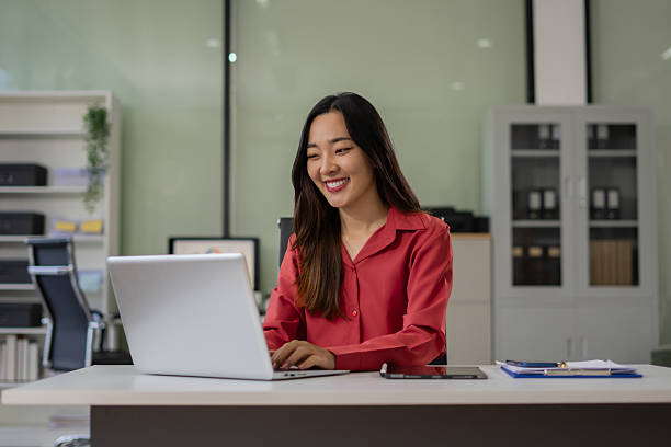 istock Businesswoman working with laptop, smartphone, and tablet. modern digital workspace concept. 2220565655