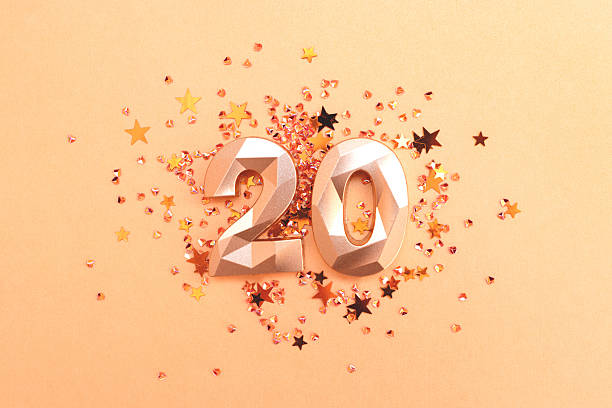 istock Golden number twenty and stars confetti. 2220566691