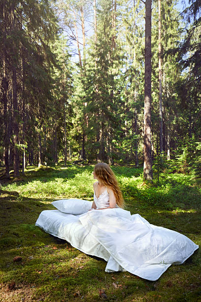 istock Girl wakes up in a summer forest 2220567740