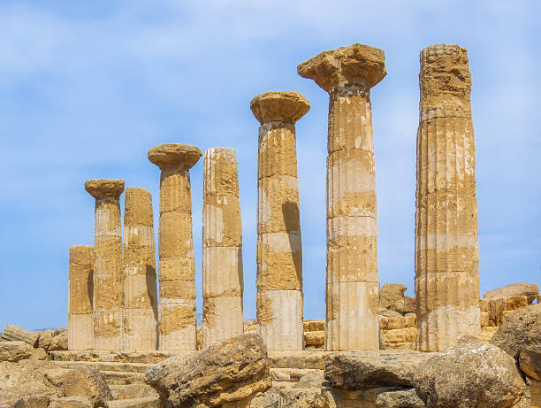 Columns of the Temple of Heracles in the Valley of the Temples, Agrigento, Italy, set against a clear blue sky. Historic architectural details of Magna Graecia. Copy space