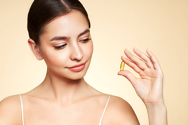 istock Beautiful Girl With Pill With Cod Liver Oil Omega-3 2220567966