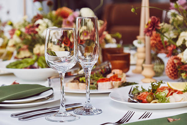 istock Aesthetics autumn table setting, arranged flowers and candles under stylish natural light. Cozy holidays table setup 2220568340