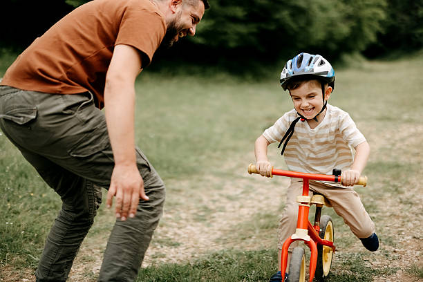 istock Father teaches son to ride a bike 2220569215
