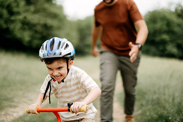 istock Father teaches son to ride a bike 2220569219