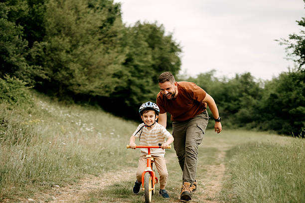 Father teaches son to ride a bike