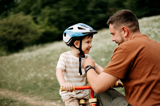 istock Father teaches son to ride a bike 2220569276