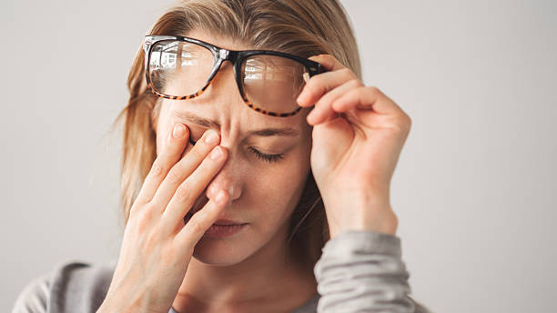 Young woman with eye pain