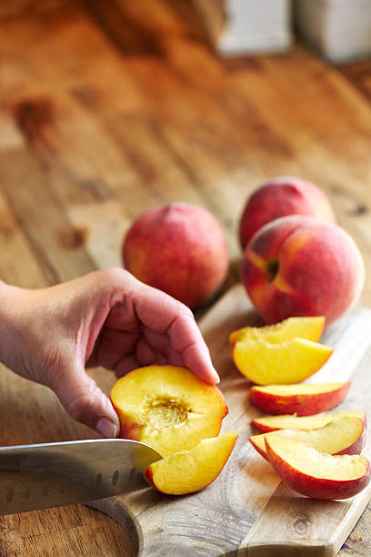 Cutting Peach Fruit on Cutting Board