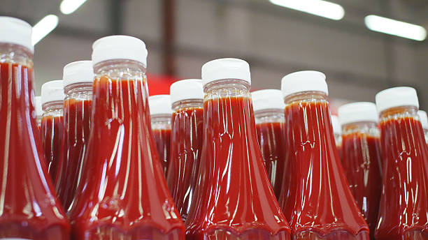 istock Many nice bottles of ketchup standing in a row 2220574656