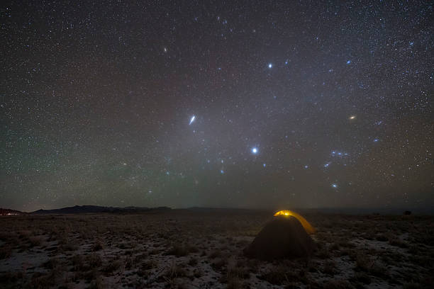 istock Camping outdoors at night under the beautiful starry sky and Milky Way 2220574694