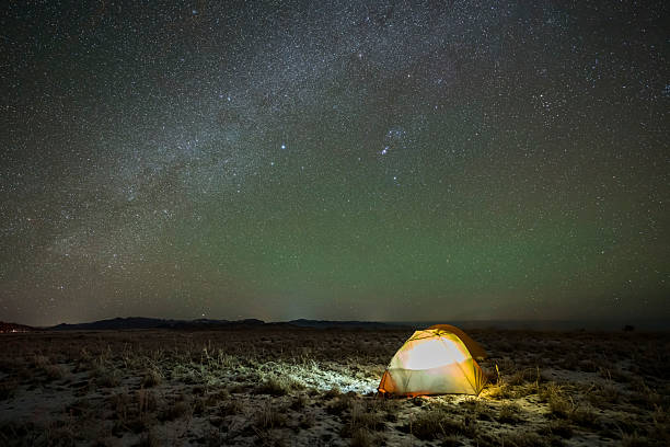 istock Camping outdoors at night under the beautiful starry sky and Milky Way 2220574696
