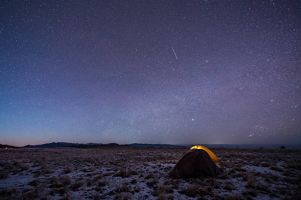 istock Camping outdoors at night under the beautiful starry sky and Milky Way 2220574701