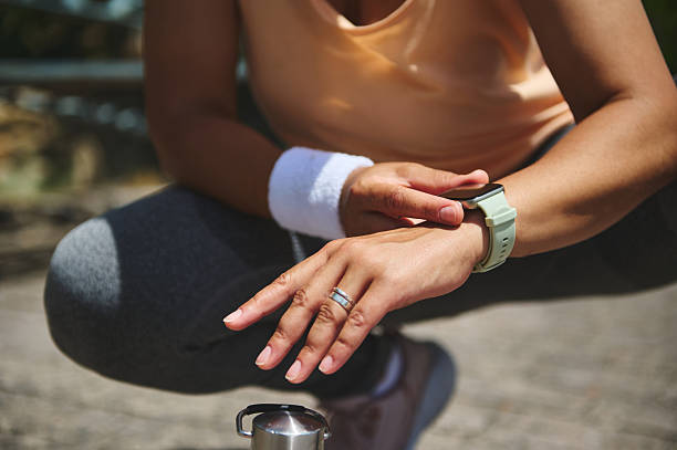istock Person Checking Fitness Tracker While Resting After Outdoor Exercise Session 2220575245