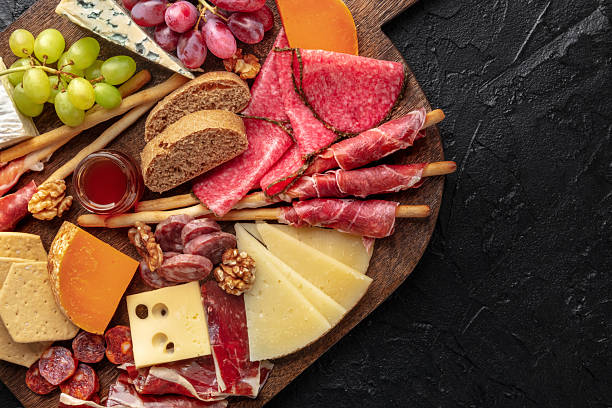 istock Antipasti or tapas. Charcuterie and cheese board with fruit, and bread 2220575512