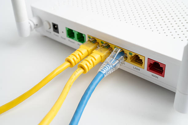 istock Ethernet cable with wireless router connect to internet service provider internet network. 2220575551
