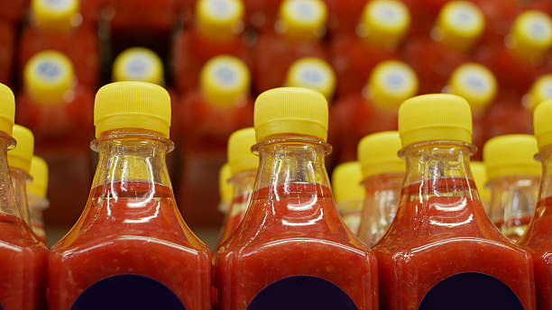 istock Close-up of many nice hot sauce bottles 2220575965