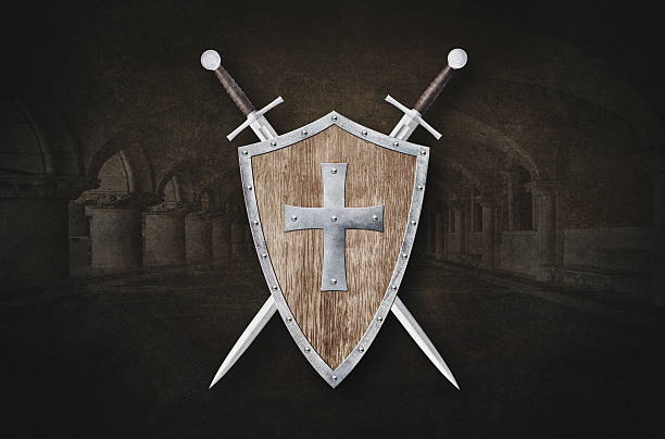 istock shield decorated with metal cross and two swords on dark background 2220576485