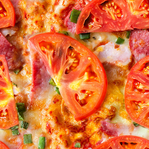 Seamless 4k photo texture of pizza with tomatoes and salami.