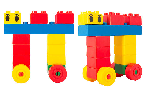 Isolated photo of colorful construction block toy toon creature with eyes on white background.