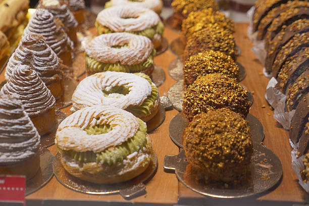 Colorful pastries attract customers during a vibrant afternoon rush.