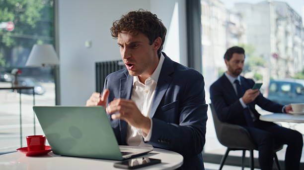istock Stressful loser sitting cafe looking laptop closeup. Mad man closing computer 2220577879