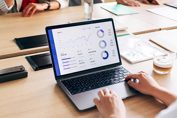 istock Professional Businessperson Analyzing Data Analytics Report on Laptop in Conference Room 2220578551