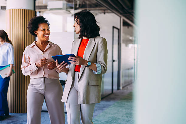 istock Professional Businesswomen Communicating in Modern Office Environment 2220578600