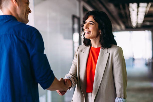Successful Business Handshake Between Confident Professionals in Modern Office Space