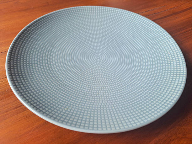 istock Emtpy Plate On Wooden Table. 2220579104