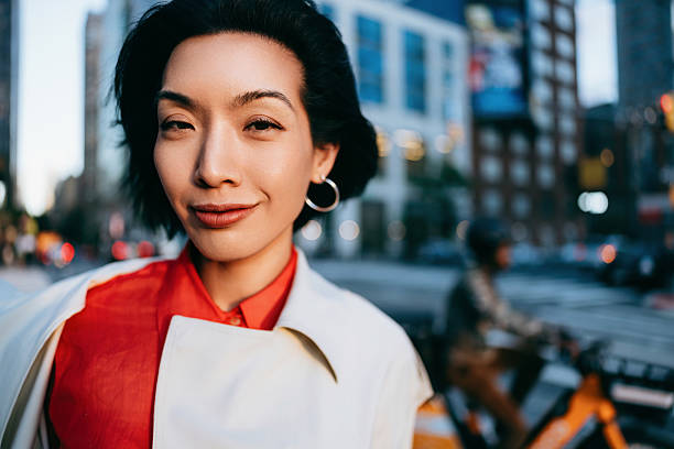 istock Confident Woman in Urban Setting With Cityscape Background in Evening Light 2220579979
