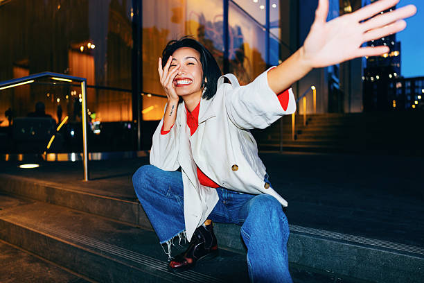 Cheerful Woman Sitting on Urban Steps at Night