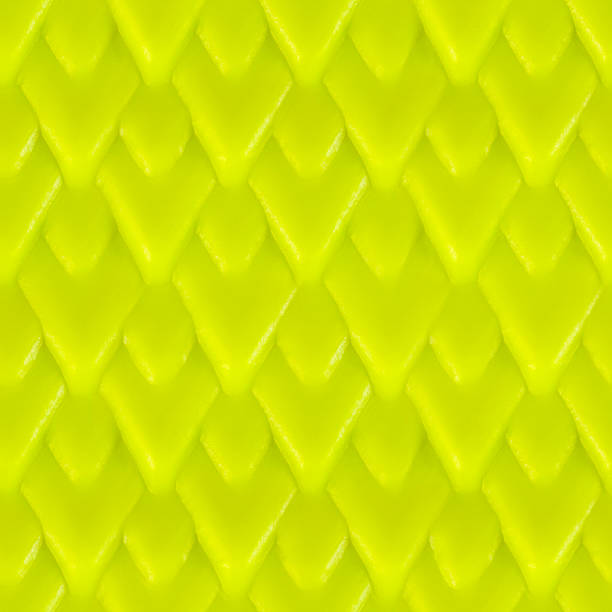 Seamless 4k photo texture material of vibrant green colored plastic or rubber scaly surface.