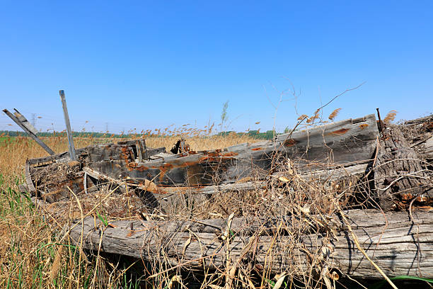 The broken wooden boat is on land