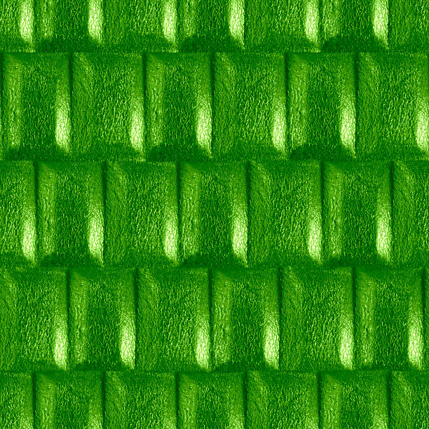 Seamless 4k photo texture material of vibrant green colored plastic tiled surface.