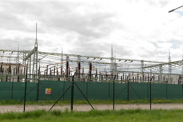 istock Electric substation infrastructure with security fencing for safety 2220581282