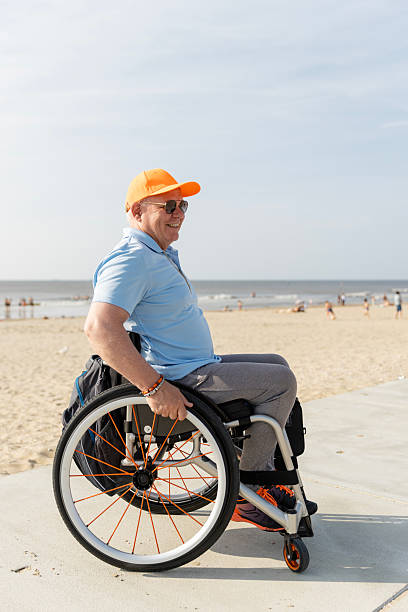 istock Handsome senior wheelchair user on a beach holiday 2220581676