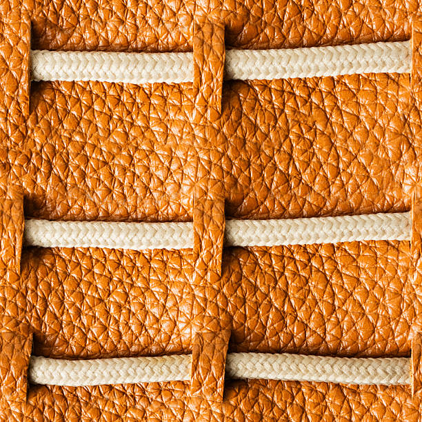 Seamless 4k photo texture material of light brown leather pattern with rope insert straps.