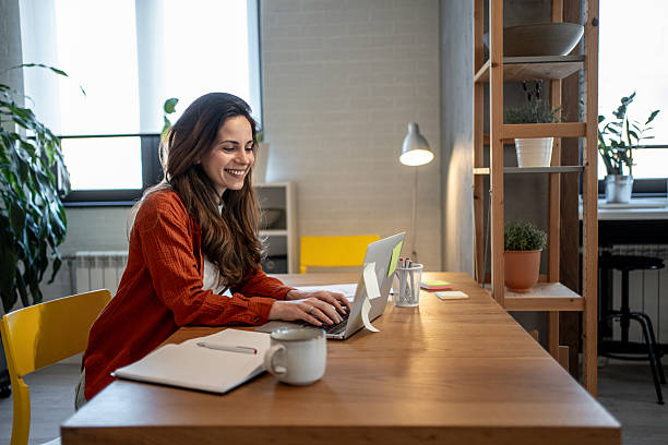 istock Young woman working from home office using laptop 2220583954