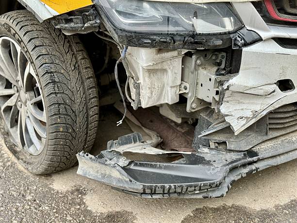 istock Car is severely damaged following a collision and road accident incident recently. This image features a detailed closeup of a car showing extensive frontend damage resulting from a serious accident 2220584471