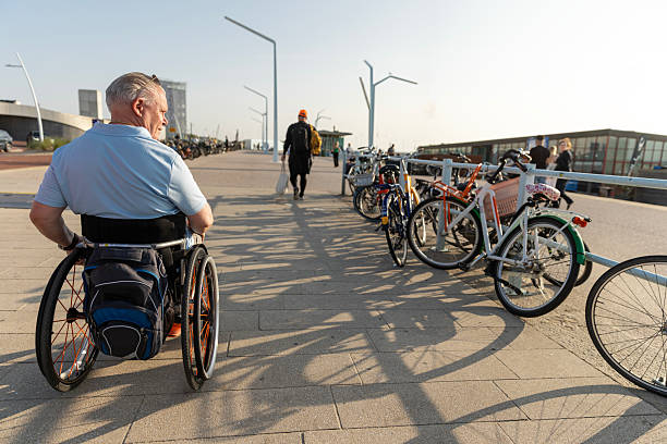 Asian elderly man pushing a wheelchair
