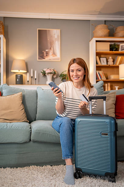 istock Woman booking a trip online using a smartphone and credit card 2220586833