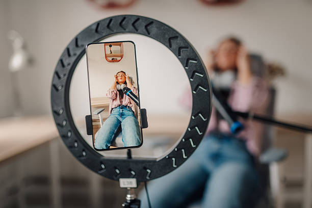 istock Content creator recording a video blog with ring light and microphone 2220589710
