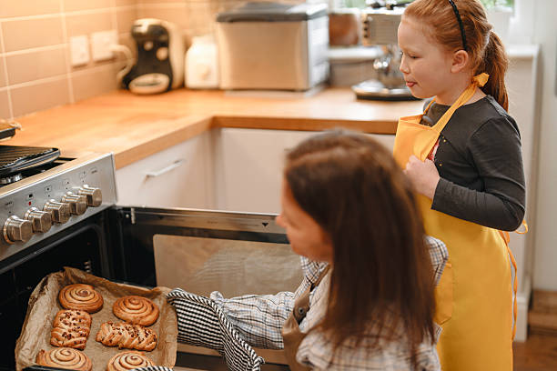 istock Baking cookies in a cozy kitchen with a child during a weekend afternoon 2220589871