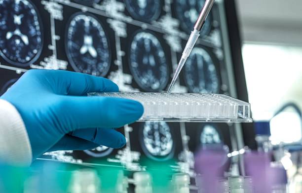 istock Scientist dispensing liquid into a multi-well plate in a laboratory setting for medical research. 2220590182