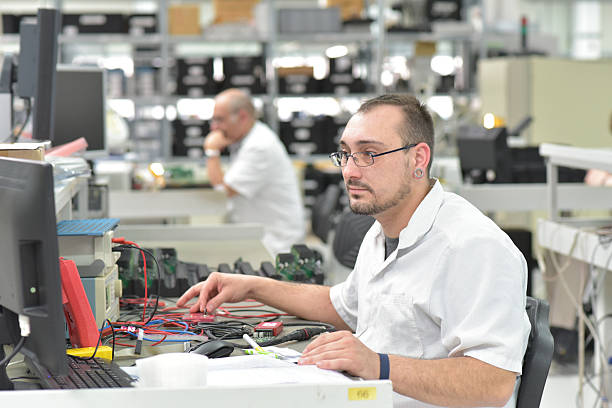 istock engineering in microelectronics: workers in the production and assembly of electronic high tech components in a modern factory 2220590762