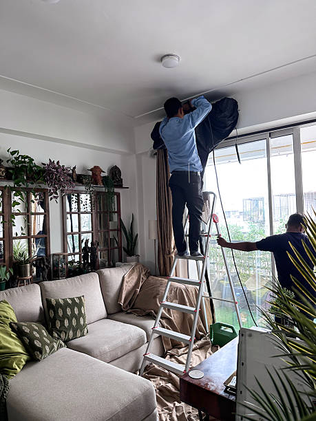 istock Image of man washing split ac cover indoors during servicing / cleaning air conditioning unit while wet to ensure efficient cooling, 2220593381