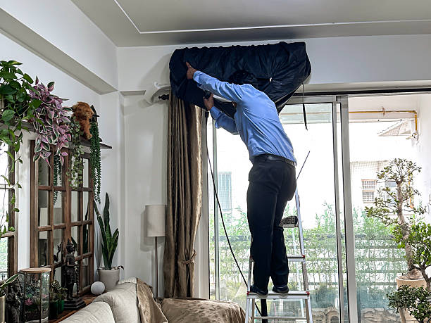 istock Image of man cleaning indoor split ac unit, washing wet cover during servicing / professional hvac maintenance 2220593387