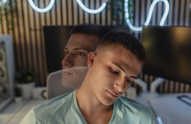 Artistic double exposure image showcasing a contemplative young man in a modern workspace, symbolizing introspection, creativity, and emotional depth, blending visual aesthetics with meaningful expression.